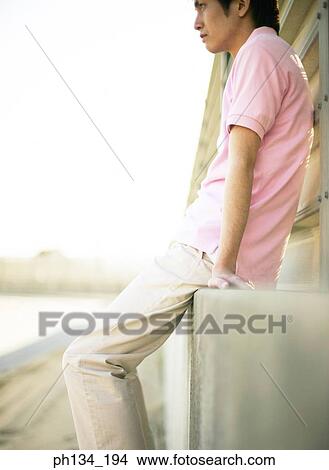 Young man sitting View Large Photo Image Picture - Young man sitting. Fotosearch