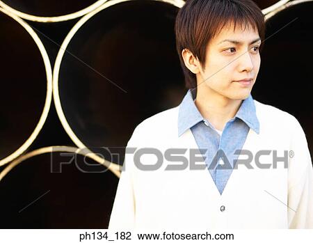 Stock Image - Young man standing. Fotosearch