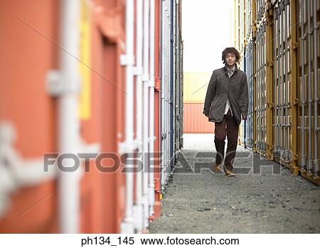 Young man walking alone View Large Photo Image Stock Photography - Young man walking alone. Fotosearch