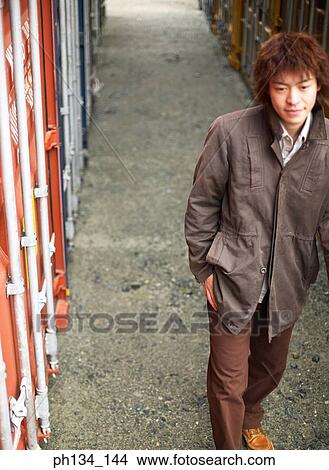 Picture - Young man walking. Fotosearch