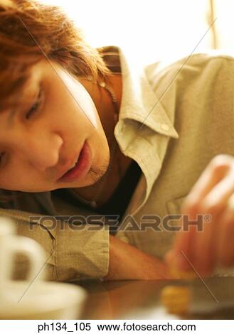 Young man with leaning forward View Large Photo Image Stock Photography - Young man with leaning forward. Fotosearch