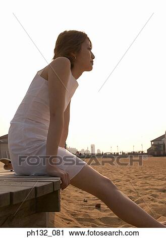 Stock Image - Young woman at the beach. Fotosearch