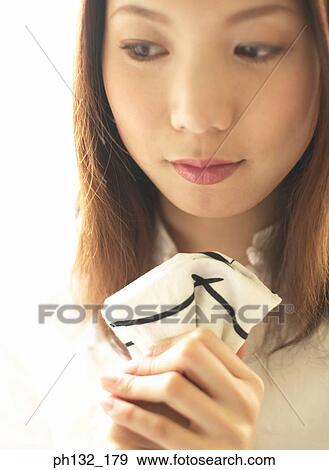 Stock Photo - Young woman holding a handkerchief. Fotosearch