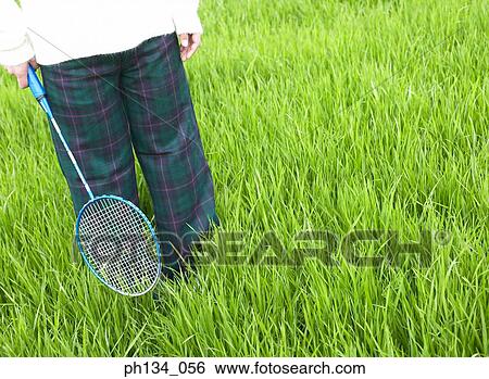 Young woman holding badminton racket View Large Photo Image Stock Photograph - Young woman holding badminton racket. Fotosearch