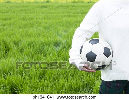 Young woman holding football View Large Photo Image Stock Image - Young woman holding football. Fotosearch