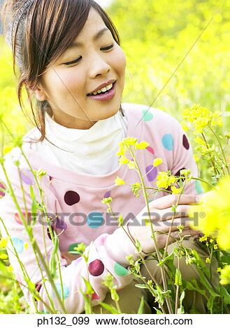 Stock Photo - Young woman in a meadow. Fotosearch