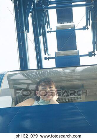 Stock Photo - Young woman in giant_wheel. Fotosearch