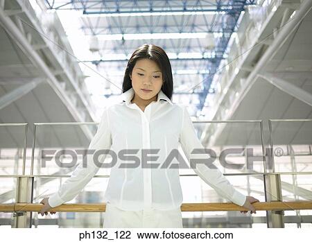 Young woman leaning on handrails View Large Photo Image Stock Image - Young woman leaning on handrails. Fotosearch