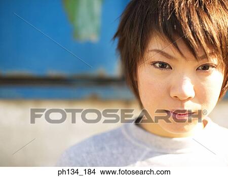 Picture - Young woman looking ahead. Fotosearch