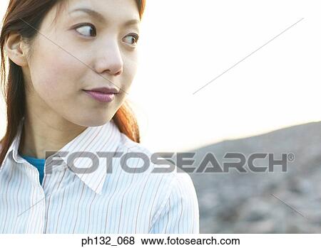 Stock Photo - Young woman looking sideways. Fotosearch