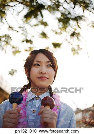 Young woman playing a musical instrument View Large Photo Image Stock Image - Young woman playing a musical instrument. Fotosearch