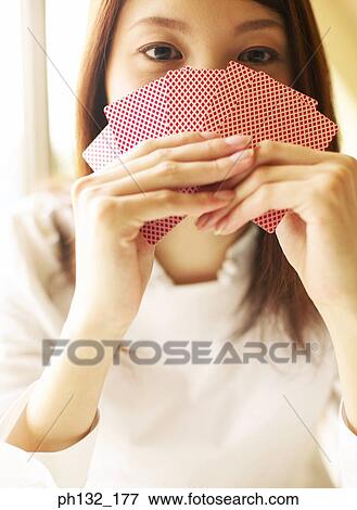 Stock Photo - Young woman playing cards. Fotosearch