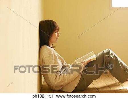 Young woman reading book View Large Photo Image Stock Image - Young woman reading book. Fotosearch