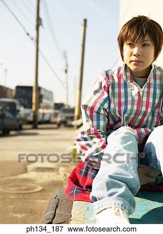 Young woman sitting View Large Photo Image Stock Photo - Young woman sitting. Fotosearch