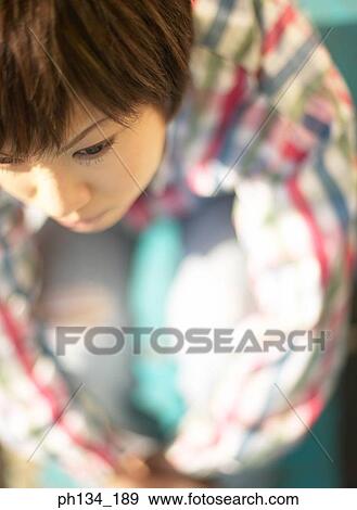 Stock Photo - Young woman sitting. Fotosearch