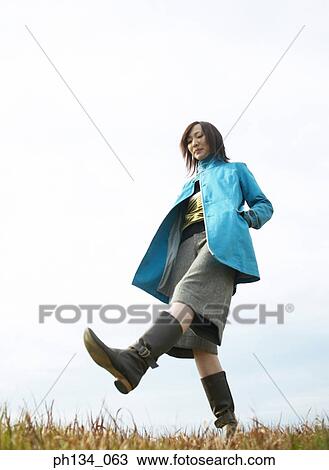 Stock Image - Young woman walking. Fotosearch