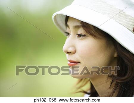 Young woman wearing a cap View Large Photo Image Stock Photo - Young woman wearing a cap. Fotosearch