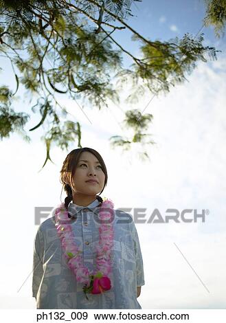 Young woman wearing a garland View Large Photo Image Stock Photo - Young woman wearing a garland. Fotosearch
