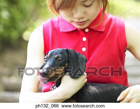 Stock Photograph - Young woman with pet dog. Fotosearch