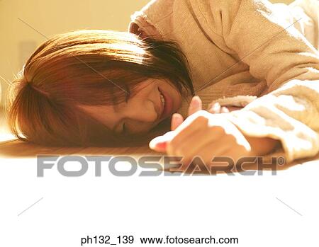 Young women lying on the floor View Large Photo Image Stock Photo - Young women lying on the floor. Fotosearch