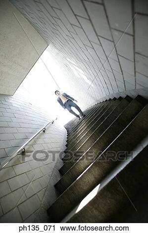 Low angle view of a young businessman coming down a flight of stairs View Large Photo Image Stock Image - Low angle view of a young businessman coming down a flight of stairs. Fotosearch