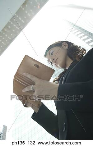 Low angle view of a young businesswoman writing in a diary View Large Photo Image Stock Image - Low angle view of a young businesswoman writing in a diary. Fotosearch