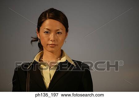 Profile of a young businesswoman looking at camera View Large Photo Image Stock Photo - Profile of a young businesswoman looking at camera. Fotosearch