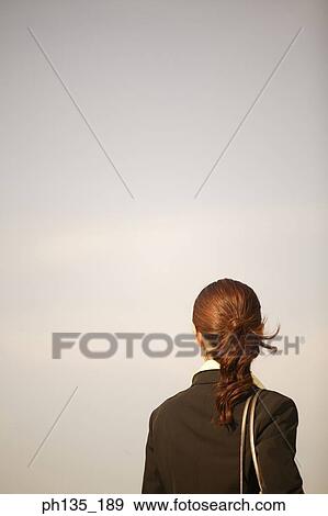 Stock Photo - Rear view of a young businesswoman. Fotosearch