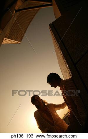 Stock Image - Silhouette of a young couple. Fotosearch