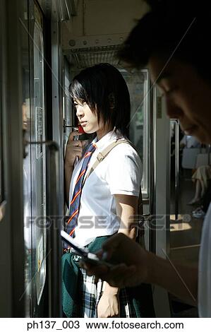 Teenage girl standing in a train looking out the Window View Large Photo Image Stock Image - Teenage girl standing in a train looking out the Window. Fotosearch