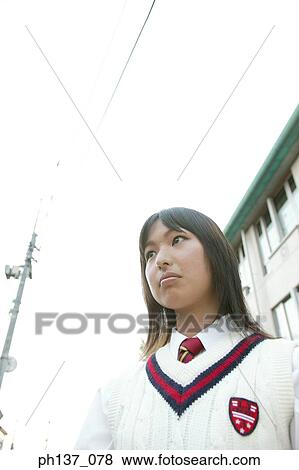 Stock Photo - Teenage girl standing outdoors. Fotosearch