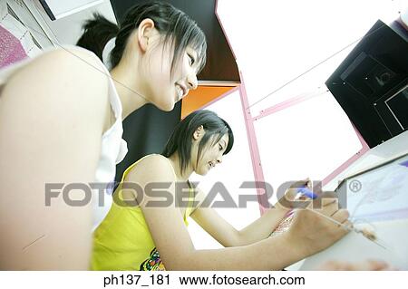 Stock Image - Teenage girls Playing video games. Fotosearch