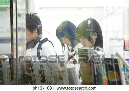 Teenage girls standing at a magazine rack View Large Photo Image Stock Image - Teenage girls standing at a magazine rack. Fotosearch