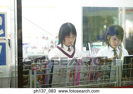 Teenage girls standing at a magazine rack View Large Photo Image Stock Image - Teenage girls standing at a magazine rack. Fotosearch