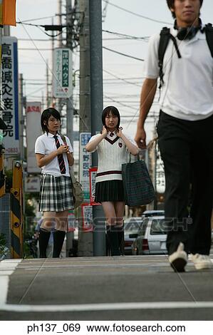 Teenagers crossing the street View Large Photo Image Stock Photo - Teenagers crossing the street. Fotosearch