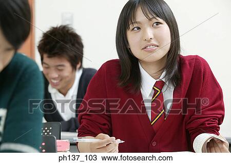 Stock Image - Teenagers in class. Fotosearch