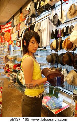 Teenagers looking at hats in a store View Large Photo Image Stock Photography - Teenagers looking at hats in a store. Fotosearch