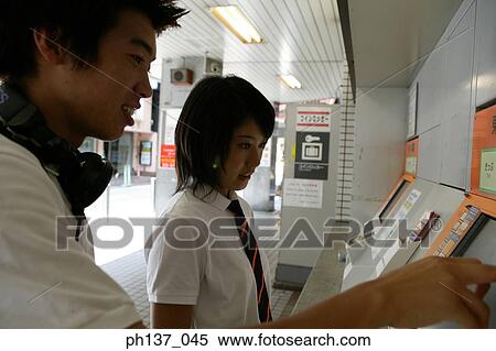 Teenagers operating a computerized vending machine View Large Photo Image Stock Photography - Teenagers operating a computerized vending machine. Fotosearch