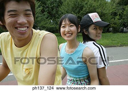 Teenagers riding a tandem bicycle View Large Photo Image Picture - Teenagers riding a tandem bicycle. Fotosearch