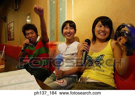 Teenagers singing at a karaoke bar View Large Photo Image Picture - Teenagers singing at a karaoke bar. Fotosearch