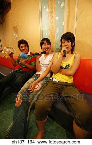 Teenagers singing at a karaoke bar View Large Photo Image Picture - Teenagers singing at a karaoke bar. Fotosearch