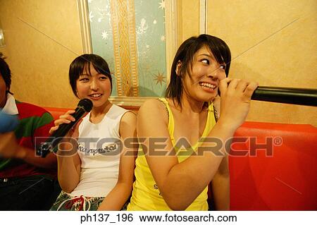 Teenagers singing at a karaoke bar View Large Photo Image Stock Photograph - Teenagers singing at a karaoke bar. Fotosearch