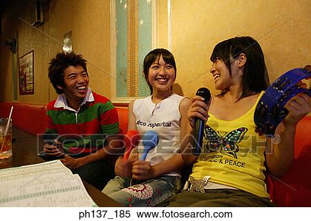 Teenagers singing at a karaoke bar View Large Photo Image Stock Photography - Teenagers singing at a karaoke bar. Fotosearch