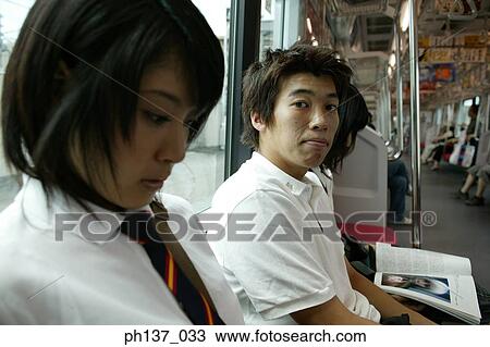 Teenagers sitting in a train View Large Photo Image Stock Image - Teenagers sitting in a train. Fotosearch