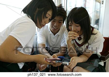 Teenagers sitting in a train talking View Large Photo Image Stock Image - Teenagers sitting in a train talking. Fotosearch