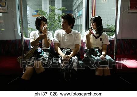 Teenagers sitting in a train talking View Large Photo Image Stock Photo - Teenagers sitting in a train talking. Fotosearch