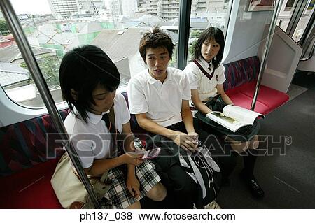 Teenagers sitting in a train talking View Large Photo Image Stock Photo - Teenagers sitting in a train talking. Fotosearch