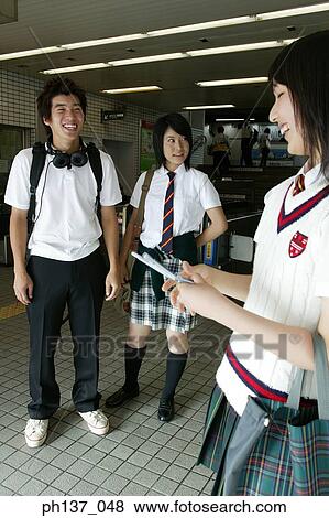 Teenagers standing and smiling View Large Photo Image Stock Photo - Teenagers standing and smiling. Fotosearch