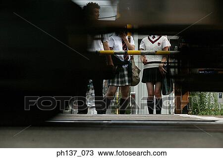 Teenagers standing and waiting at a railway crossing View Large Photo Image Stock Image - Teenagers standing and waiting at a railway crossing. Fotosearch