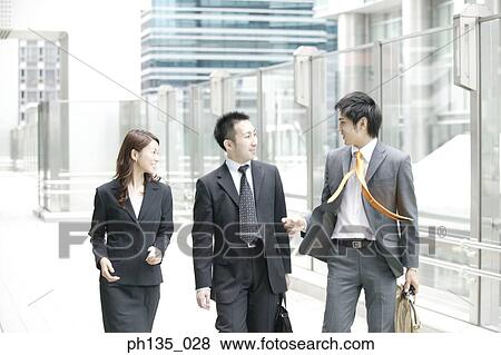 Three co-workers walking outdoors View Large Photo Image Stock Photo - Three co-workers walking outdoors. Fotosearch